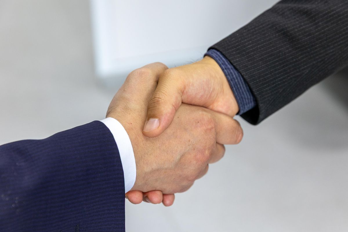 Business partners shaking hands after reaching an agreement
